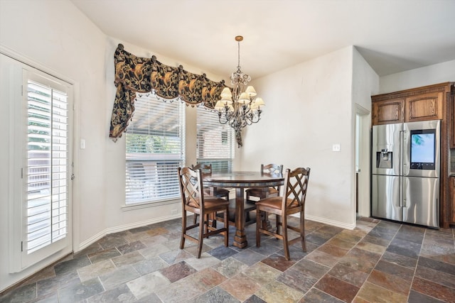 dining space featuring a wealth of natural light and a chandelier