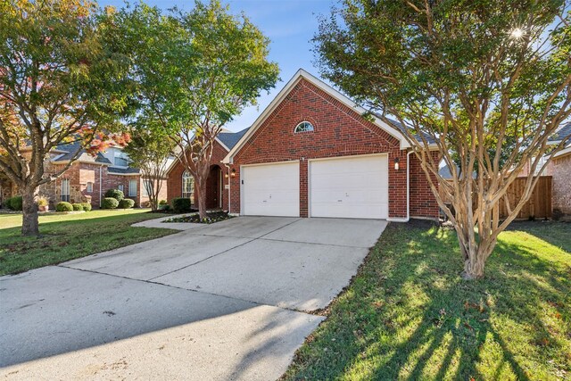 view of front of house with a garage and a front lawn