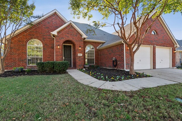 front of property featuring a front yard and a garage