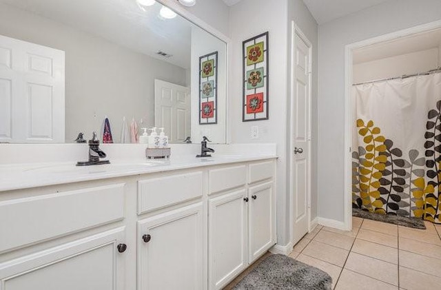 bathroom with vanity, curtained shower, and tile patterned floors