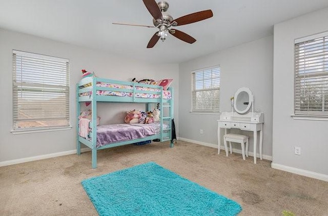 bedroom with multiple windows, carpet floors, and ceiling fan