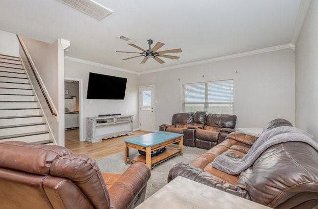 living room with crown molding, light hardwood / wood-style floors, and ceiling fan