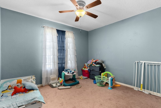 bedroom featuring ceiling fan, carpet, and a textured ceiling