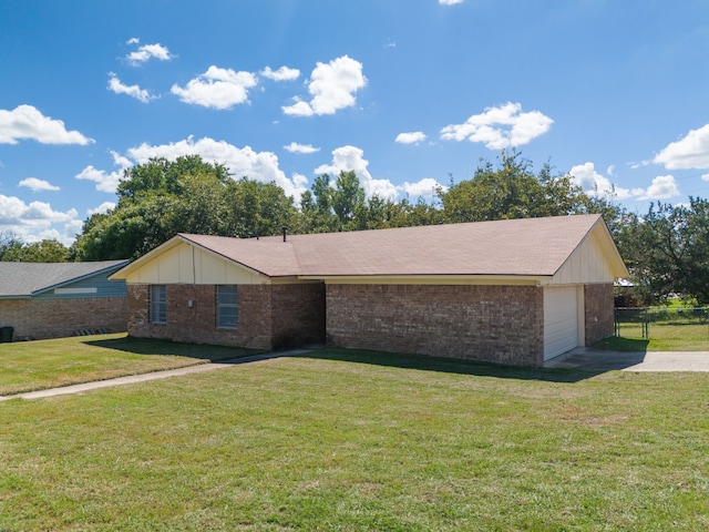 single story home featuring driveway, brick siding, a front yard, and fence