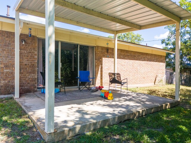 rear view of house featuring a yard and a patio area