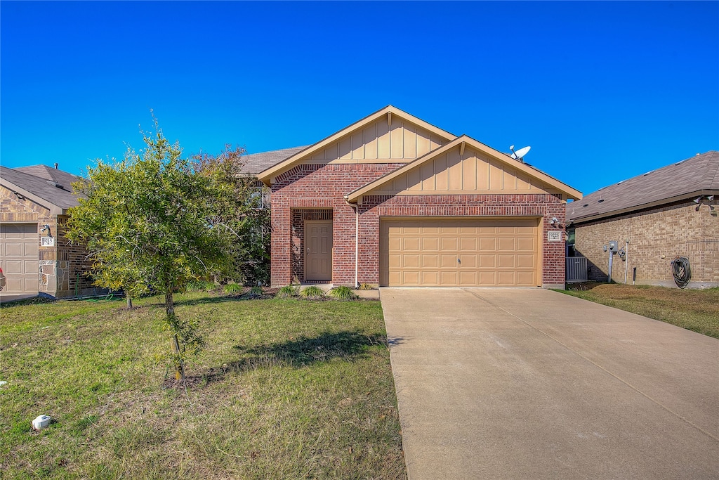 ranch-style house with a front yard and a garage