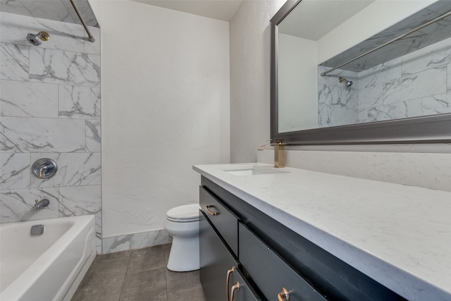 full bathroom featuring vanity, tiled shower / bath combo, toilet, and tile patterned flooring