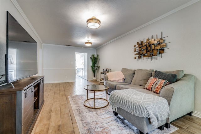 living room with a textured ceiling, light hardwood / wood-style floors, and ornamental molding