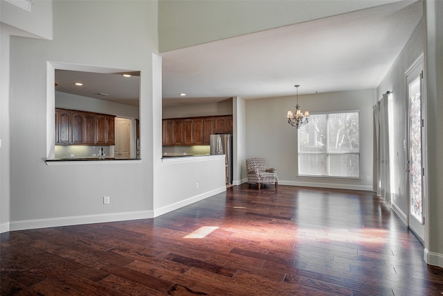 interior space with sink, dark hardwood / wood-style floors, and an inviting chandelier