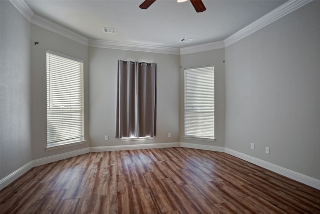 spare room featuring crown molding, hardwood / wood-style floors, and a healthy amount of sunlight