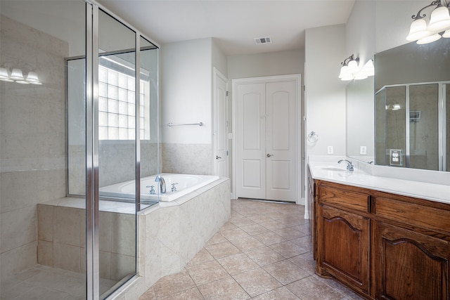 bathroom featuring tile patterned floors, vanity, and plus walk in shower