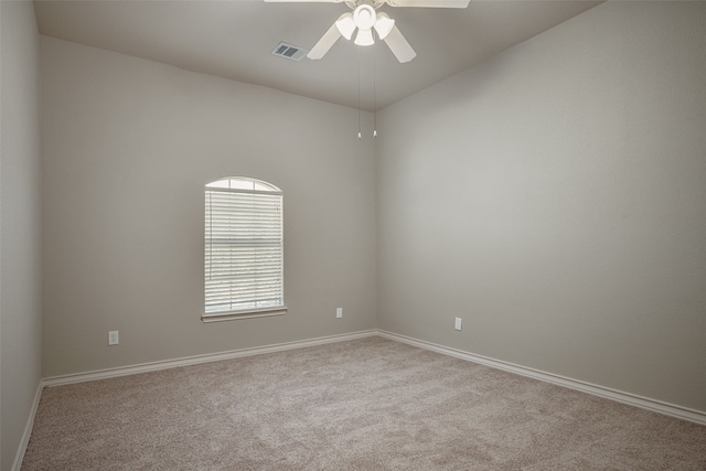 carpeted spare room with ceiling fan