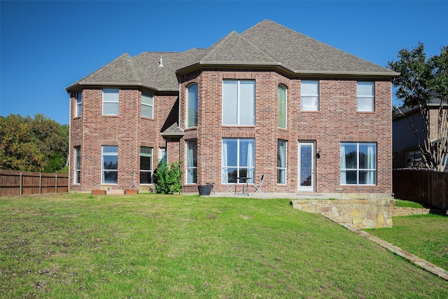 rear view of house with a lawn