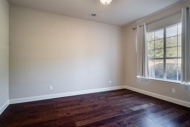 spare room with dark hardwood / wood-style floors