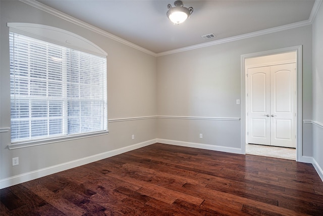 spare room with dark hardwood / wood-style floors and ornamental molding