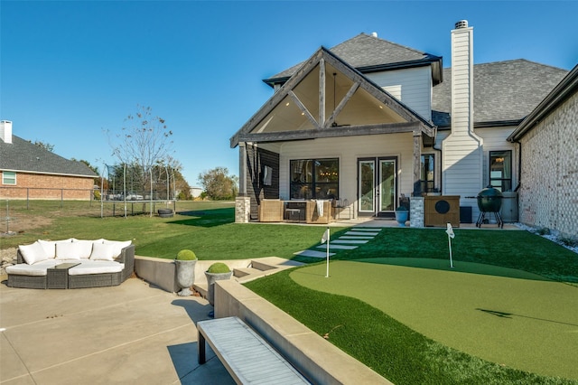 back of property featuring a patio, a trampoline, and an outdoor hangout area