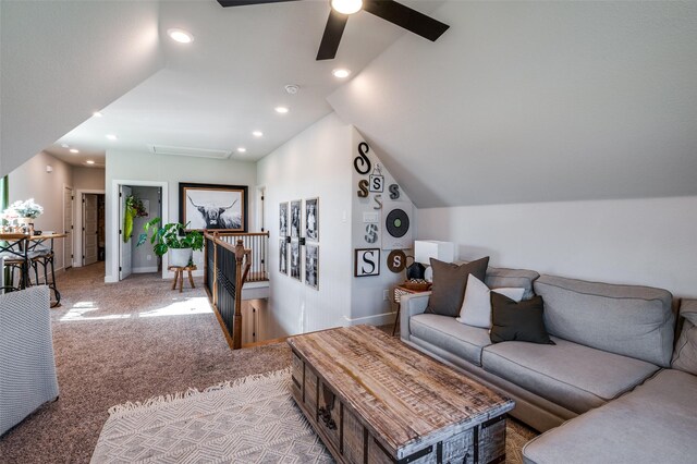 living room with ceiling fan, light carpet, and lofted ceiling