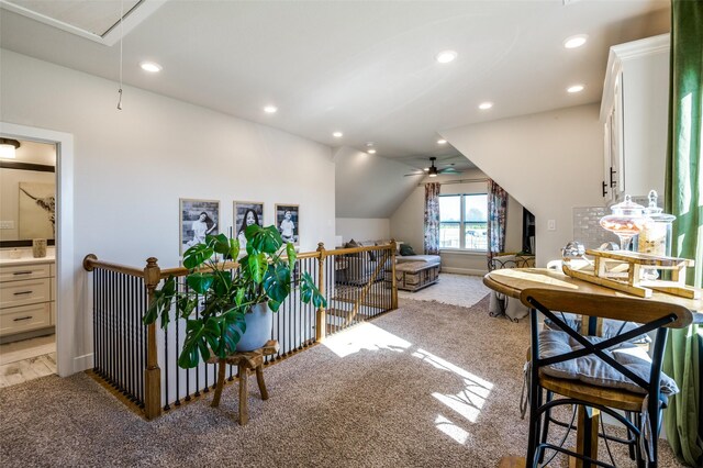 interior space with ceiling fan, light colored carpet, and lofted ceiling