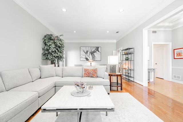 living room featuring crown molding and light hardwood / wood-style flooring