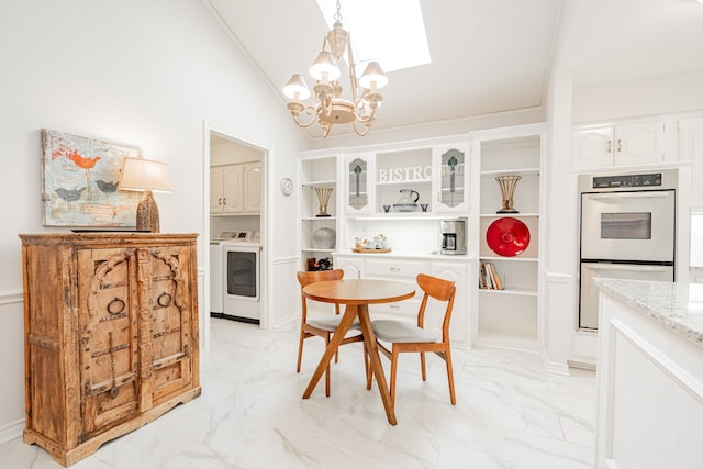 dining space featuring marble finish floor, a chandelier, and lofted ceiling with skylight