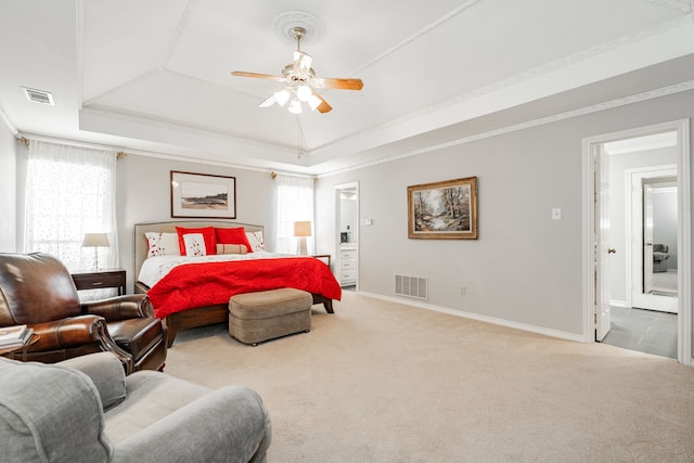 bedroom featuring a tray ceiling, carpet, visible vents, and baseboards