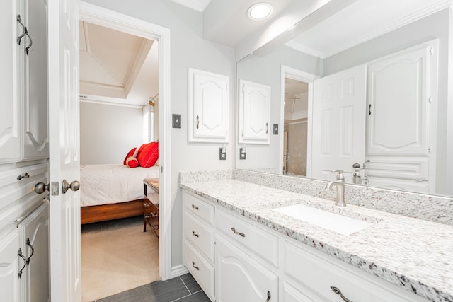 ensuite bathroom with connected bathroom and vanity