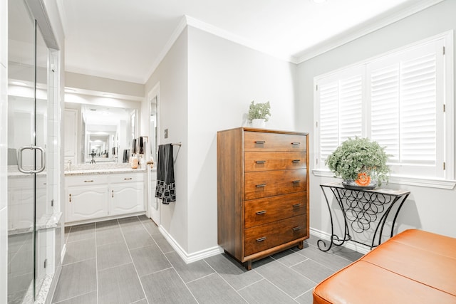 full bathroom featuring ornamental molding, a stall shower, vanity, and baseboards