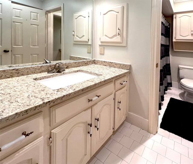 full bath featuring toilet, tile patterned floors, baseboards, and vanity