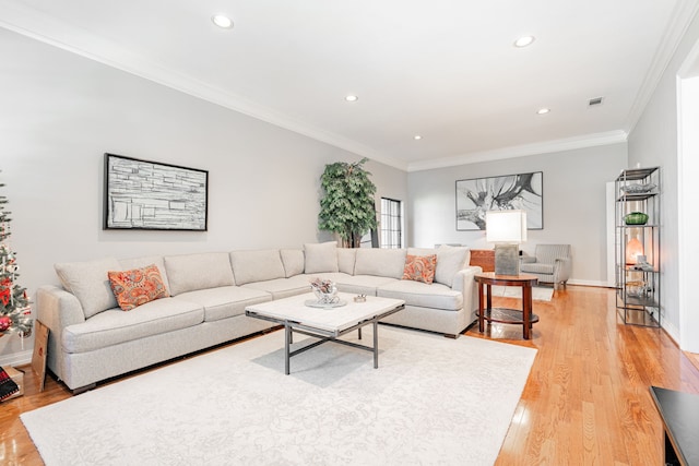 living area with recessed lighting, visible vents, ornamental molding, light wood-type flooring, and baseboards