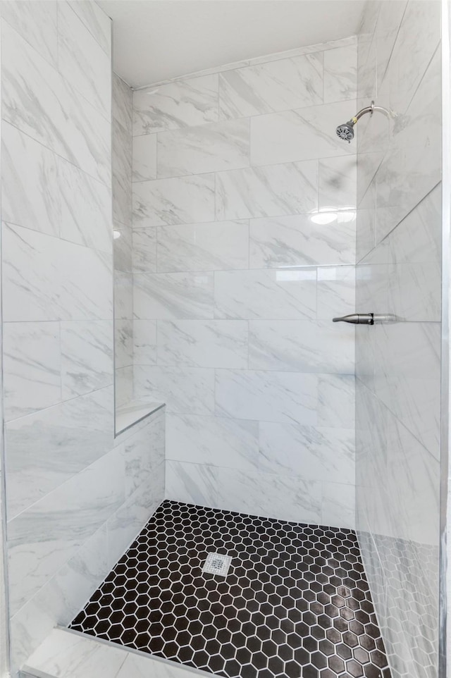 bathroom with a tile shower