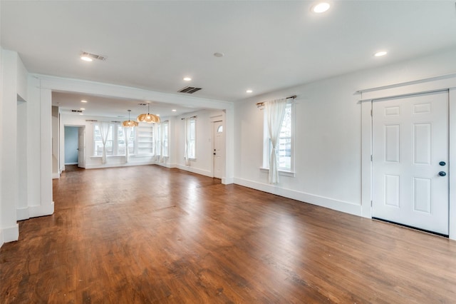 unfurnished living room featuring baseboards, visible vents, wood finished floors, and recessed lighting