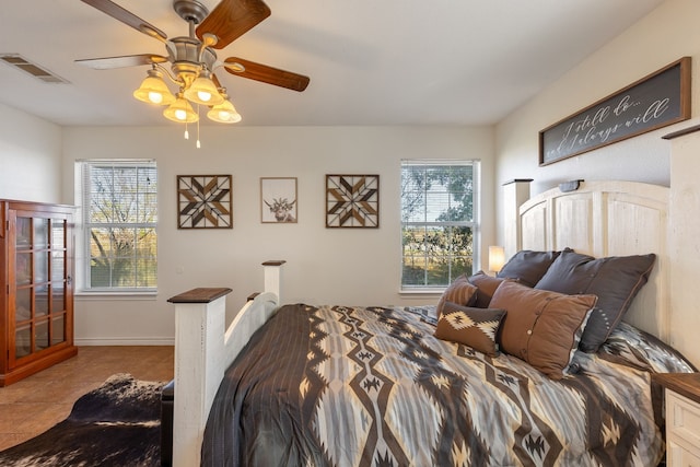 tiled bedroom featuring ceiling fan