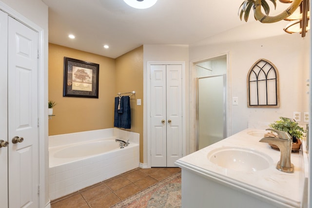 bathroom with tile patterned flooring, vanity, and shower with separate bathtub