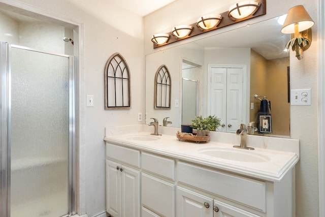 bathroom with vanity and a shower with door