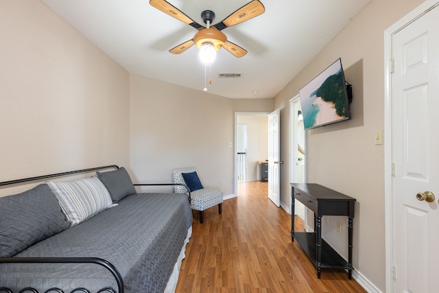 living room featuring ceiling fan and wood-type flooring