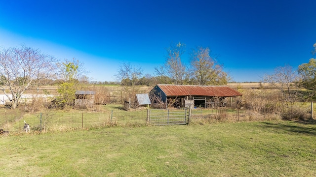 view of yard with a rural view and an outdoor structure