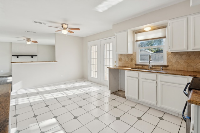 kitchen with range with electric stovetop, decorative backsplash, and white cabinets