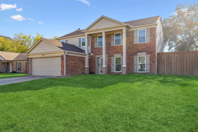 view of front of property with a garage and a front lawn