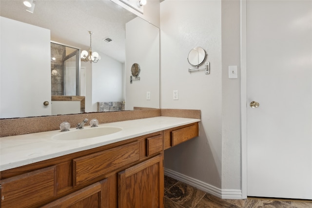 bathroom with a notable chandelier and vanity