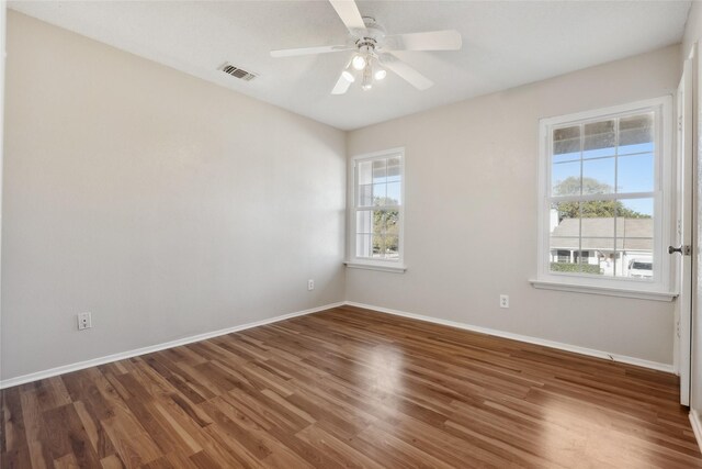 spare room with dark hardwood / wood-style floors and ceiling fan