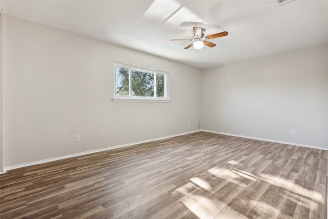 empty room featuring hardwood / wood-style floors and ceiling fan