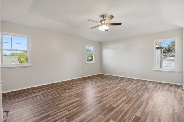 empty room with ceiling fan and dark wood-type flooring