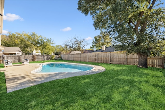 view of swimming pool with a yard and a patio area