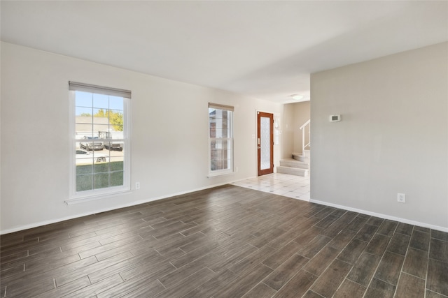 spare room with dark hardwood / wood-style flooring