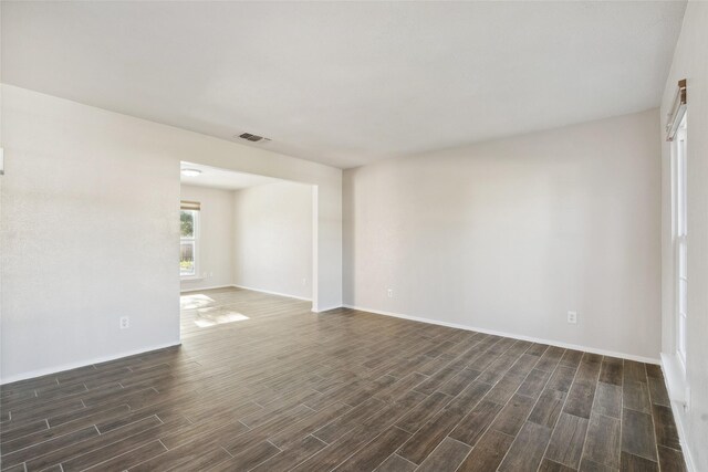 empty room with dark hardwood / wood-style floors