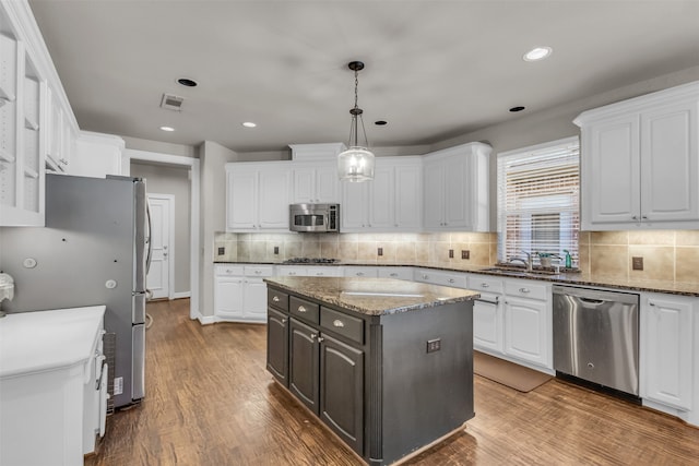 dining room with hardwood / wood-style floors, a wealth of natural light, and a notable chandelier