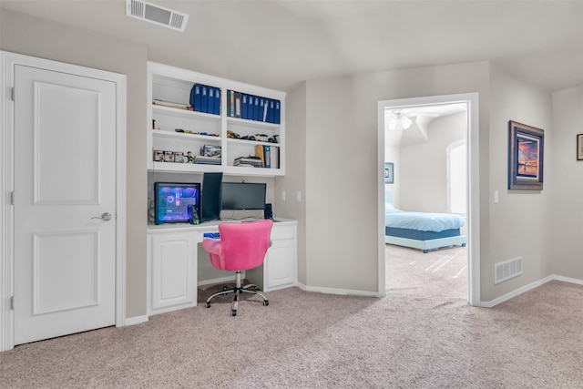 carpeted office with ceiling fan