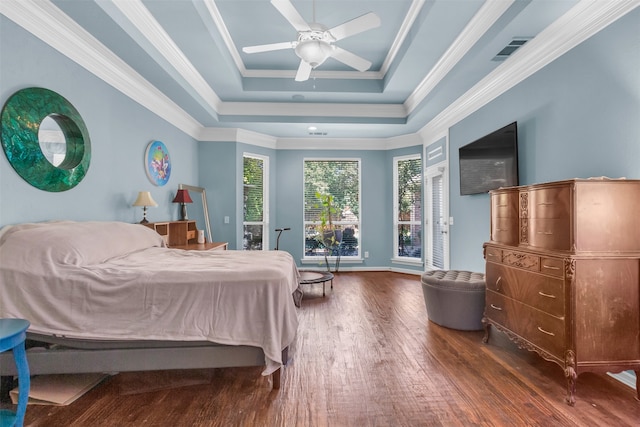 bedroom featuring a raised ceiling, ceiling fan, crown molding, and dark wood-type flooring