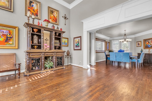 dining room with ornamental molding, dark hardwood / wood-style floors, and a notable chandelier