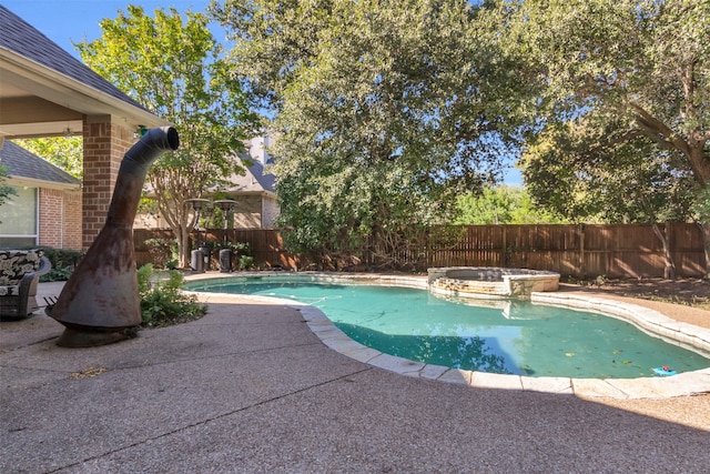 view of swimming pool featuring a patio area and an in ground hot tub